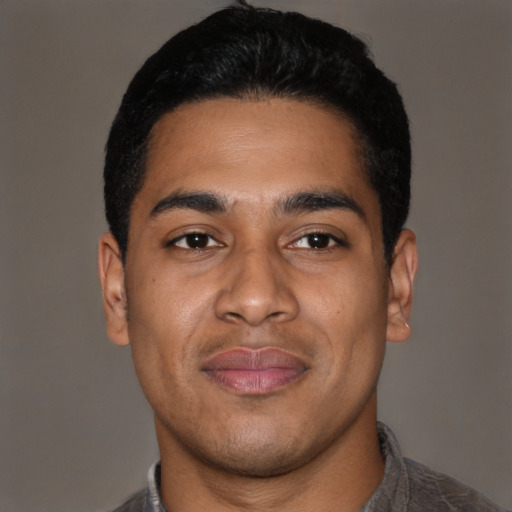 Joyful latino young-adult male with short  black hair and brown eyes