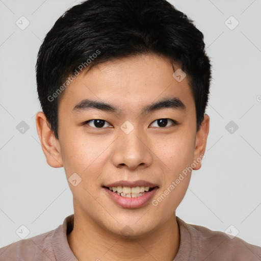 Joyful asian young-adult male with short  brown hair and brown eyes