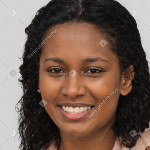 Joyful black young-adult female with long  brown hair and brown eyes