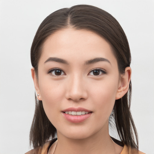 Joyful white young-adult female with long  brown hair and brown eyes