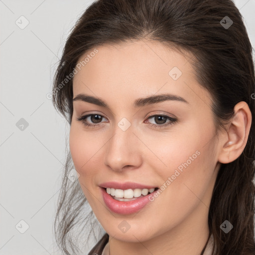 Joyful white young-adult female with long  brown hair and brown eyes