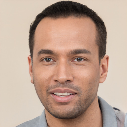 Joyful white young-adult male with short  black hair and brown eyes