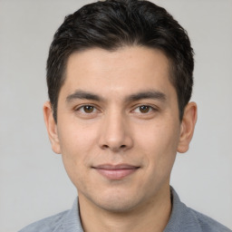 Joyful white young-adult male with short  black hair and brown eyes