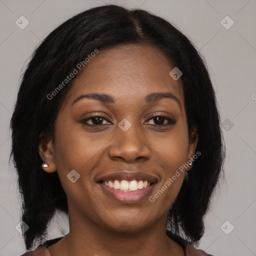 Joyful black young-adult female with medium  black hair and brown eyes