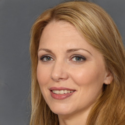 Joyful white adult female with long  brown hair and brown eyes