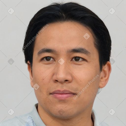 Joyful asian adult male with short  black hair and brown eyes