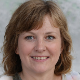 Joyful white young-adult female with medium  brown hair and blue eyes