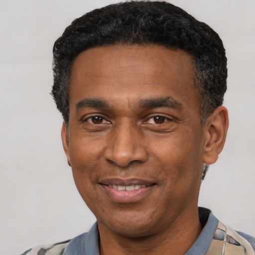Joyful latino adult male with short  black hair and brown eyes