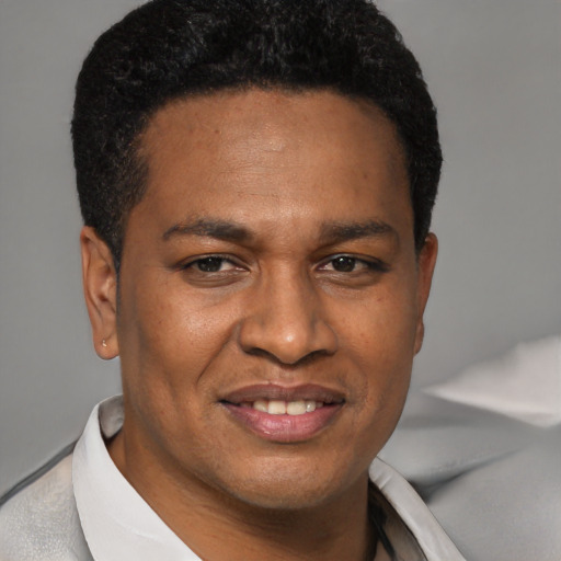Joyful latino young-adult male with short  black hair and brown eyes