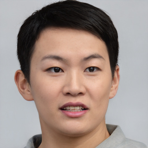 Joyful asian young-adult female with short  black hair and brown eyes