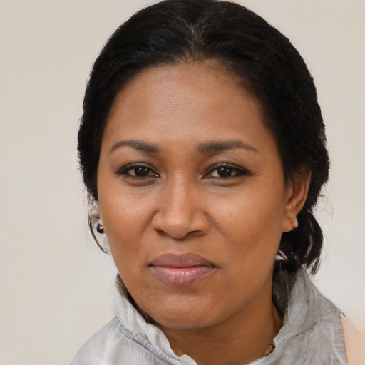Joyful black adult female with short  black hair and brown eyes