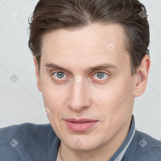 Joyful white adult male with short  brown hair and grey eyes