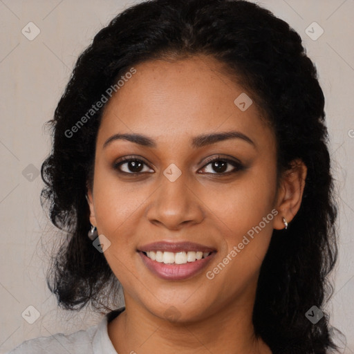 Joyful black young-adult female with long  black hair and brown eyes