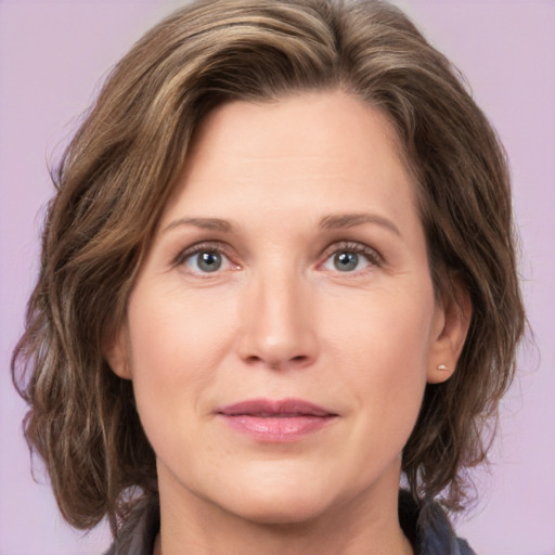 Joyful white young-adult female with medium  brown hair and green eyes