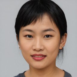 Joyful asian young-adult female with medium  black hair and brown eyes