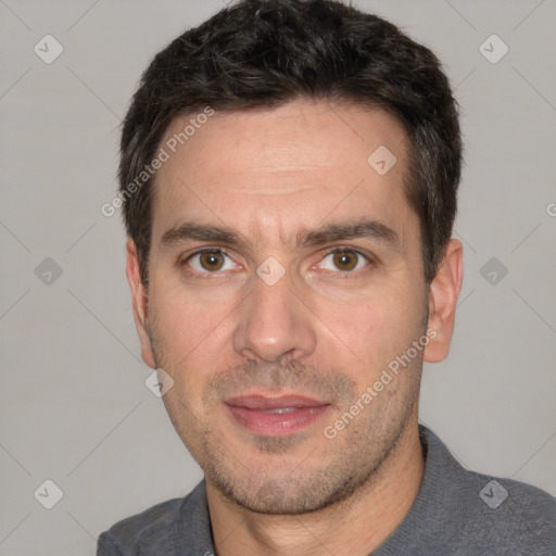 Joyful white adult male with short  black hair and brown eyes