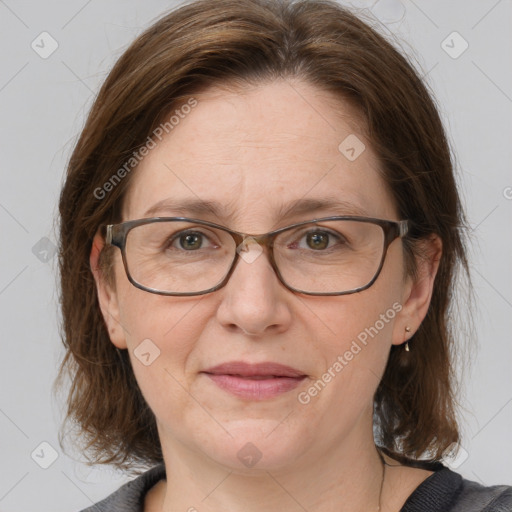 Joyful white adult female with medium  brown hair and grey eyes