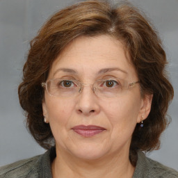 Joyful white adult female with medium  brown hair and blue eyes