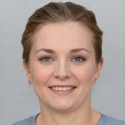 Joyful white young-adult female with short  brown hair and grey eyes