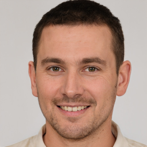 Joyful white young-adult male with short  brown hair and brown eyes