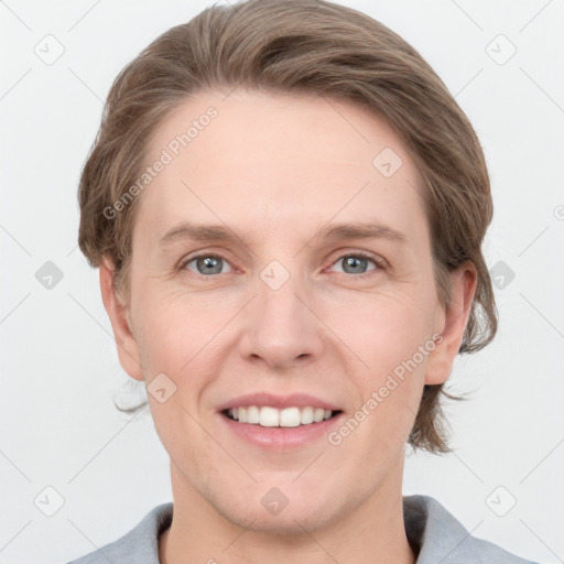 Joyful white adult female with medium  brown hair and grey eyes