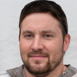 Joyful white adult male with short  brown hair and grey eyes