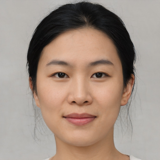 Joyful asian young-adult female with medium  black hair and brown eyes