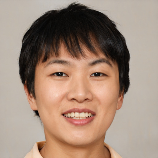 Joyful asian young-adult female with short  brown hair and brown eyes