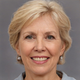 Joyful white middle-aged female with medium  blond hair and brown eyes