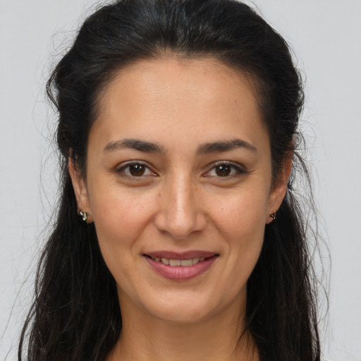 Joyful white young-adult female with long  brown hair and brown eyes