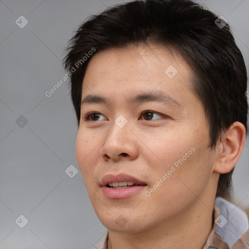 Joyful asian young-adult male with short  brown hair and brown eyes