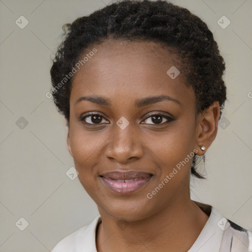 Joyful black young-adult female with short  black hair and brown eyes