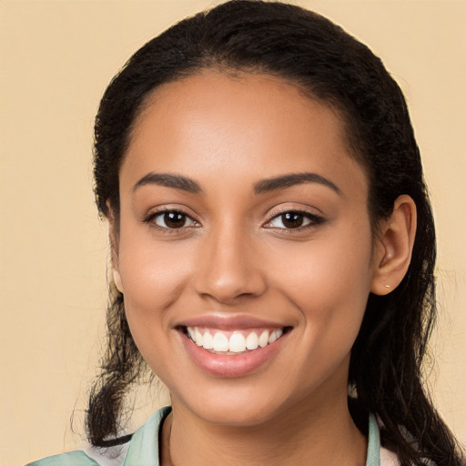 Joyful latino young-adult female with long  black hair and brown eyes