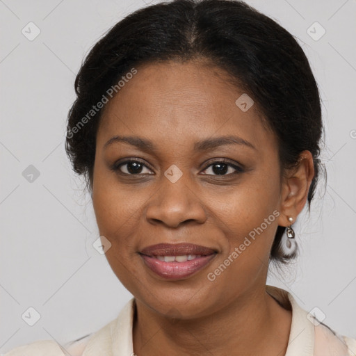 Joyful black adult female with medium  brown hair and brown eyes