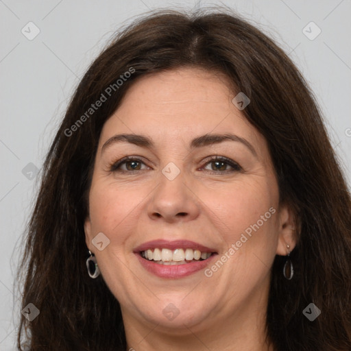 Joyful white adult female with long  brown hair and brown eyes