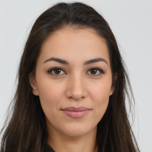 Joyful latino young-adult female with long  brown hair and brown eyes