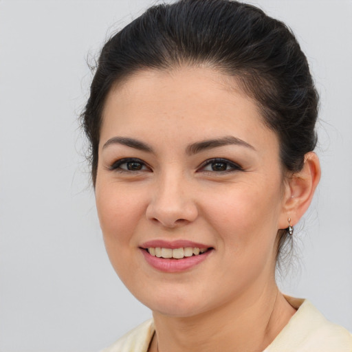 Joyful latino young-adult female with medium  brown hair and brown eyes