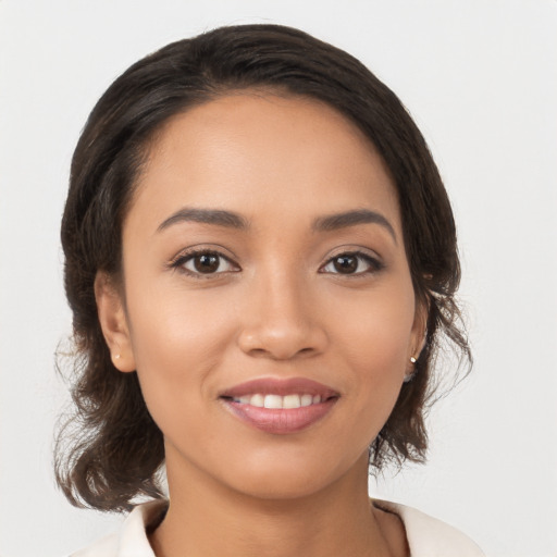 Joyful latino young-adult female with medium  brown hair and brown eyes