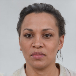 Joyful latino adult female with short  brown hair and brown eyes