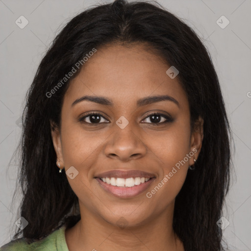 Joyful black young-adult female with long  brown hair and brown eyes