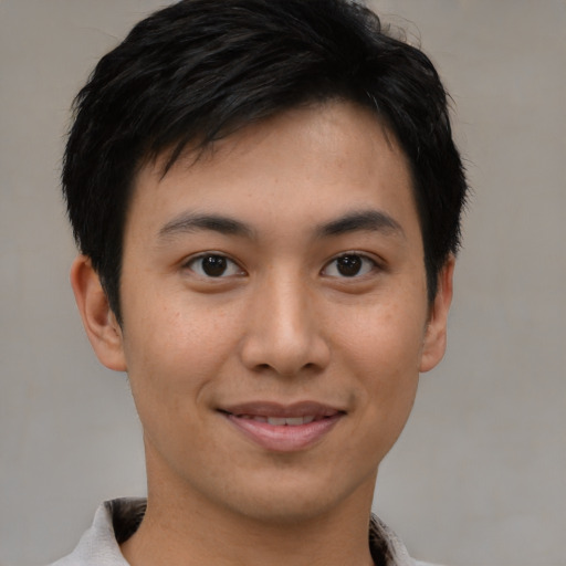 Joyful asian young-adult male with short  brown hair and brown eyes