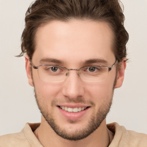 Joyful white young-adult male with short  brown hair and grey eyes