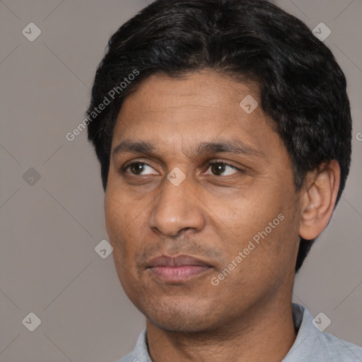 Joyful white adult male with short  black hair and brown eyes
