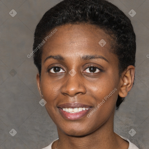 Joyful black young-adult female with short  black hair and brown eyes