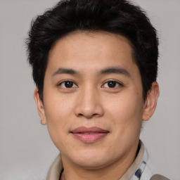 Joyful asian young-adult male with short  brown hair and brown eyes