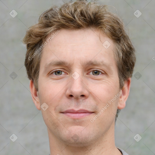 Joyful white adult male with short  brown hair and grey eyes