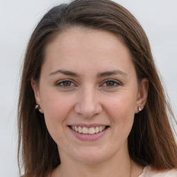 Joyful white young-adult female with long  brown hair and grey eyes