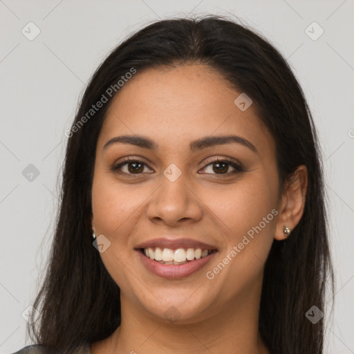 Joyful latino young-adult female with long  brown hair and brown eyes