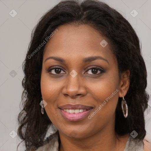 Joyful black young-adult female with long  brown hair and brown eyes