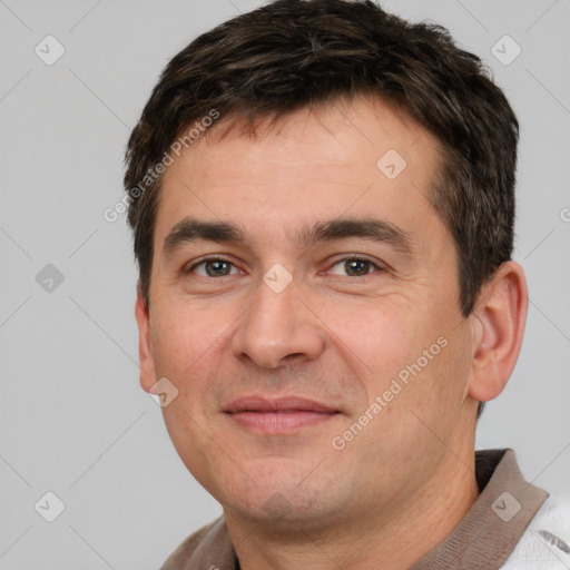 Joyful white adult male with short  brown hair and brown eyes